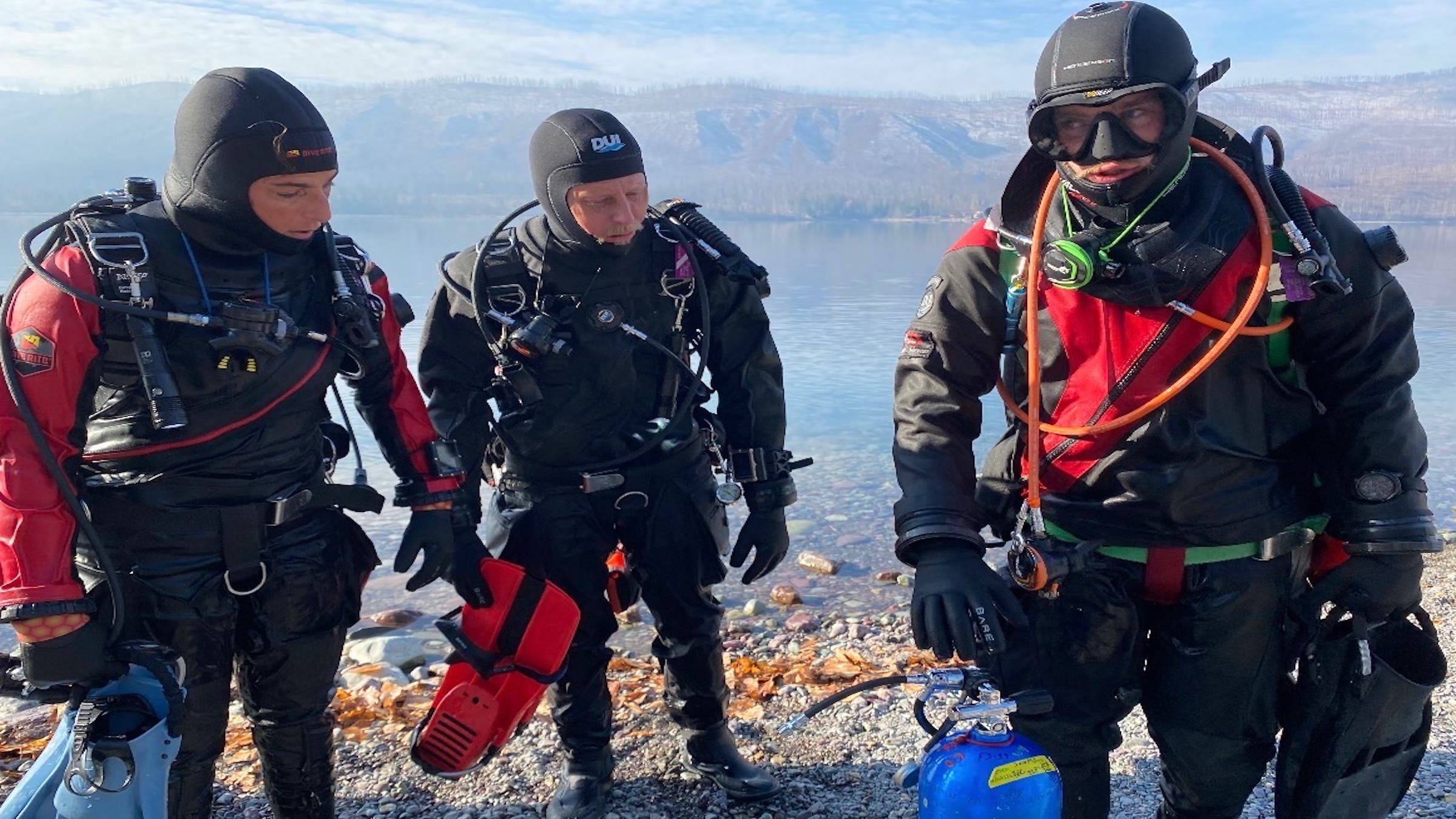 Nick, far right, completes a drysuit dive at Lake Mcdonald on the third anniversary of Linnea's death